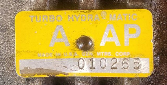 Close-up of OEM part identification tag on transmission